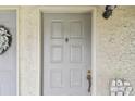 Close up of the unit front door with a decorative wreath and a small welcome sign at 6262 142Nd N Ave # 1302, Clearwater, FL 33760