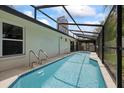 Inviting in-ground swimming pool with a screened enclosure, perfect for year-round enjoyment at 6706 Dunes Ln, Temple Terrace, FL 33617