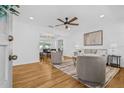 Bright living room with hardwood floors, neutral furniture, ceiling fan, and view of dining room at 8010 Par N Ave, St Petersburg, FL 33710