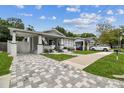 Charming home featuring a quaint front porch, freshly painted exterior, and beautifully manicured landscaping at 904 E Hamilton Ave, Tampa, FL 33604