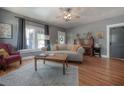 Bright living room with hardwood floors, a comfortable couch, and large windows at 917 W Idlewild Ave, Tampa, FL 33604