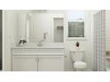 Bright bathroom with a quartz vanity, framed mirror, and tiled shower with curtain and natural light at 9542 Minnow Ray Dr, Land O Lakes, FL 34638