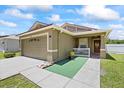 Charming single-Gathering home with a well-kept lawn, two-car garage and inviting front entrance with white rails at 9831 Edmonton Dr, Land O Lakes, FL 34638