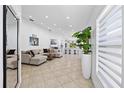 Open-concept living room features tile flooring, recessed lighting, and a comfortable sectional sofa at 9831 Edmonton Dr, Land O Lakes, FL 34638