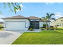 Beautiful single-story home featuring a well-maintained lawn, landscaping, and a two-car garage at 12830 24Th Street E Cir, Parrish, FL 34219