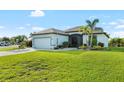 Inviting single-story home with a lush green lawn and a well-manicured garden in the front yard at 12830 24Th Street E Cir, Parrish, FL 34219