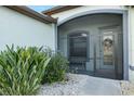 Enclosed front porch area with seating and decorative touches, surrounded by lush greenery at 12830 24Th Street E Cir, Parrish, FL 34219