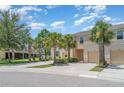Exterior of a townhouse showcasing well-maintained landscaping, driveway, and a glimpse of the neighborhood at 12841 Buffalo Run Dr, Gibsonton, FL 33534
