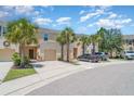 Townhouse with a two-car garage, manicured landscaping, and convenient parking available on the street at 12841 Buffalo Run Dr, Gibsonton, FL 33534