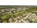 Aerial view featuring the home with a screened enclosure and golf course in the neighborhood at 13003 Carlington Ln, Riverview, FL 33579