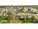 Aerial view showcasing the home, neighborhood, and a pond in the distance at 13003 Carlington Ln, Riverview, FL 33579