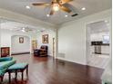 Open-concept living room featuring hardwood floors and stylish decor with seamless transitions to other rooms at 1402 Provincetown Cir, Lutz, FL 33549