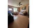 Neutral living room with ceiling fan, futon, natural light, and wood laminate floors at 1420 36Th N Ave, St Petersburg, FL 33704