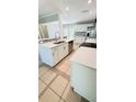 Modern kitchen with stainless steel appliances, quartz counters, and white cabinets at 1507 W Le Compte Dr, Tampa, FL 33604