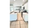 Bright kitchen features quartz counters, white cabinets, and stainless steel appliances at 1507 W Le Compte Dr, Tampa, FL 33604