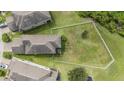 Aerial view of a home with a large, fenced backyard surrounded by lush greenery at 1634 Acadia Harbor Pl, Brandon, FL 33511
