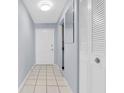 Entryway with tile flooring, closet, white door and mirror at 1706 Belleair Forest Dr # 146, Belleair, FL 33756