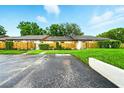 Charming townhouse exterior with well-maintained landscaping and convenient parking space at 1725 Pine Ridge E Way # E, Palm Harbor, FL 34684