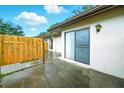 Enclosed patio with access to the main house, featuring sliding glass door and updated lighting at 1725 Pine Ridge E Way # E, Palm Harbor, FL 34684