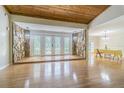 Grand entryway showcasing a wooden ceiling, stone accents, hardwood floors, and ornate glass doors at 18110 30Th St, Lutz, FL 33559
