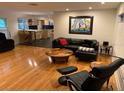 Bright living room with hardwood floors, modern furniture, and an open floor plan at 1861 Harmony Dr, Clearwater, FL 33756