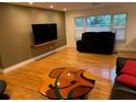 Spacious living room with hardwood floors, comfortable seating, and ample natural light at 1861 Harmony Dr, Clearwater, FL 33756