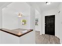 Bright entryway showcasing modern flooring and freshly painted walls, leading to a spacious living area at 2325 W Knollwood Pl, Tampa, FL 33604