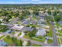 An aerial view shows the neighborhood with lush greenery, single Gathering homes and a clear blue sky at 2708 W Bird St, Tampa, FL 33614