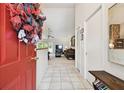 Welcoming foyer featuring tile flooring, a coat closet, and a glimpse into the living room at 2868 Denmarsh Ct, Palm Harbor, FL 34684