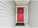 Inviting front door with a festive red wreath and sidelight window at 2868 Denmarsh Ct, Palm Harbor, FL 34684