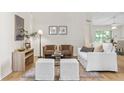 Bright living room with neutral tones, stylish furniture, wood-look flooring and an elegant area rug at 30260 Birdhouse Dr, Wesley Chapel, FL 33545