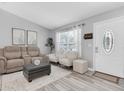 Bright living room with modern decor, comfortable seating, and an inviting front entry at 3226 Coventry N, Safety Harbor, FL 34695