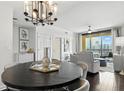 Living space with access to dining room with modern table and light fixture and views of the city skyline at 345 Bayshore Blvd # 1510, Tampa, FL 33606