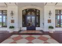 Elegant building entrance with decorative tile flooring and lush potted plants at 345 Bayshore Blvd # 1510, Tampa, FL 33606