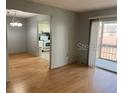 Bright living room featuring beautiful wood flooring and a sliding glass door to a balcony at 3535 41St S Ter # 219, St Petersburg, FL 33701