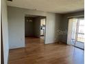 Bright living room featuring beautiful wood flooring and a sliding glass door to a balcony at 3535 41St S Ter # 219, St Petersburg, FL 33701