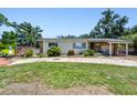 Inviting single-story home showcasing stone details, a covered carport, and a neatly kept front yard at 3601 27Th S Ave, St Petersburg, FL 33711