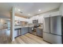 Updated kitchen with stainless steel appliances, white cabinets, and modern countertops at 367 Countryside Key Blvd, Oldsmar, FL 34677