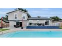 Backyard oasis with a refreshing pool and a spacious deck, ideal for outdoor entertaining and relaxation at 3721 Casaba Loop, Valrico, FL 33596