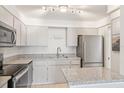Bright kitchen featuring stainless steel appliances and granite countertops at 400 64Th Ave # 202, St Pete Beach, FL 33706