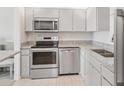 Well-lit kitchen featuring modern stainless steel appliances and ample counter space at 400 64Th Ave # 202, St Pete Beach, FL 33706
