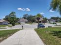 Street view of a quiet neighborhood featuring well-maintained lawns and varied home styles at 4707 Barrett Ct, Tampa, FL 33617
