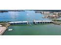 Stunning aerial view showcasing a bridge spanning turquoise waters, surrounded by lush landscapes and cityscape at 4775 Cove Cir # 803, St Petersburg, FL 33708