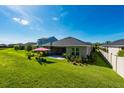 Expansive backyard with lush green lawn, mature trees, patio, and space for outdoor enjoyment at 4906 Los Robles Ct, Palmetto, FL 34221