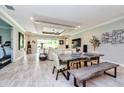 Bright and airy dining area with a custom table, an elegant ceiling, and sliding glass doors to the backyard at 4906 Los Robles Ct, Palmetto, FL 34221