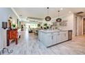 Open-concept kitchen with a large island, modern appliances, and stylish pendant lighting at 4906 Los Robles Ct, Palmetto, FL 34221