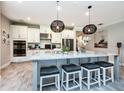 Modern kitchen with an island, granite countertops, pendant lighting, and stainless appliances at 4906 Los Robles Ct, Palmetto, FL 34221