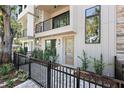 Close-up of a modern townhome entrance with a wood door, sleek lines, and a landscaped front garden at 50 64Th S St, St Petersburg, FL 33707