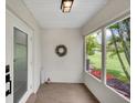 Inviting enclosed entryway featuring a modern door, a decorative wreath, and plenty of natural light at 511 Foxglove Cir # B, Sun City Center, FL 33573