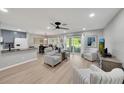 Open-concept living room with modern furnishings, sleek floors, and sliding glass doors to the outdoor patio at 511 Foxglove Cir # B, Sun City Center, FL 33573